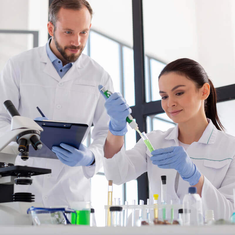 Scientists performing cell therapy device and reagent validation testing